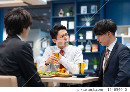 A businessman having a drinking party with his subordinates A businessman having a drinking party with his subordinates 134654040