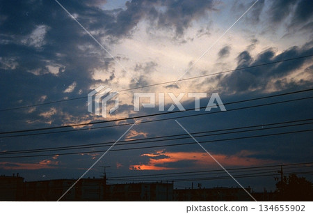 Clouds and cityscape silhouettes dyed in the sunset. Perfect for background material, image cuts, and emotional expressions. Clouds and cityscape silhouettes dyed in the sunset. Perfect for background material, image cuts, and emotional expressions. 134655902