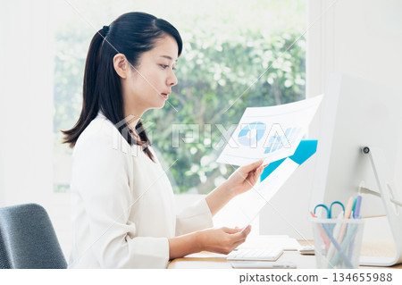 Young woman doing office work Young woman doing office work 134655988