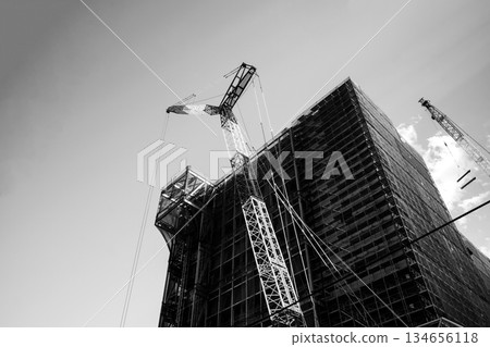 Huge building under construction and crane c-4 monochrome Huge building under construction and crane c-4 monochrome 134656118
