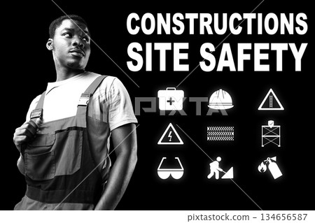 Construction worker emphasizes site safety with key symbols in a bold display 134656587