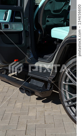 Luxury SUV parked with open door showcasing stylish interior and sleek design features 134656600