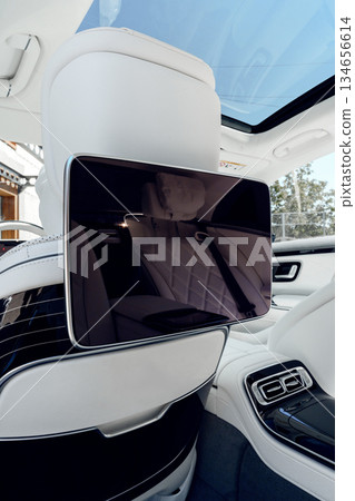 High-tech entertainment screen in luxury vehicle interior during daytime High-tech entertainment screen in luxury vehicle interior during daytime 134656614