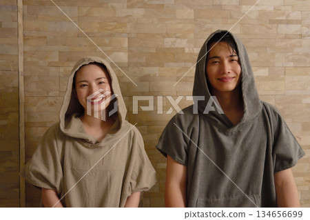 Young couple using the sauna Young couple using the sauna 134656699
