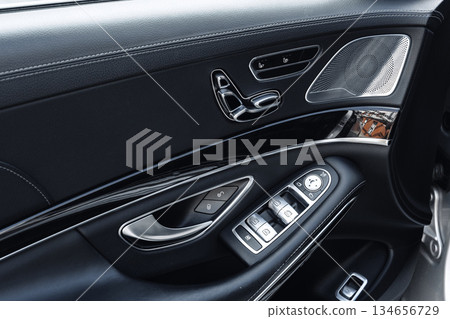 Detailed view of luxury car interior showcasing modern controls and design elements Detailed view of luxury car interior showcasing modern controls and design elements 134656729