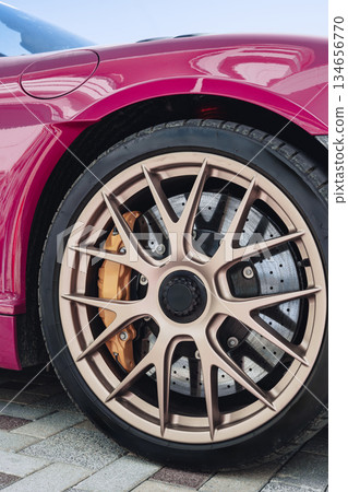 Luxury car with stylish wheels parked on modern pavement during daytime Luxury car with stylish wheels parked on modern pavement during daytime 134656770