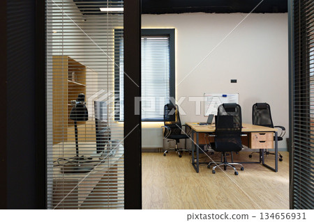 Modern office setting with sleek furniture and bright natural light during work hours Modern office setting with sleek furniture and bright natural light during work hours 134656931