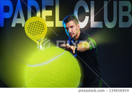Male player practicing padel sport with fluorescent ball in indoor court setting 134656954