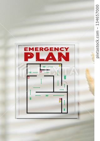 Emergency plan layout displayed on a wall with sunlight shadows creating patterns Emergency plan layout displayed on a wall with sunlight shadows creating patterns 134657000
