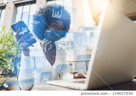 Woman working on laptop with digital data displayed on screen in an outdoor setting 134657030