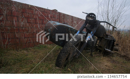 rusted motorcycle beside crashed aircraft fuselage, parked near brick wall under overcast sky, tall grass and weeds reclaiming frame, textured oxidation and flaking paint, vintage military aesthetic rusted motorcycle beside crashed aircraft fuselage, parked near brick wall under overcast sky, tall grass and weeds reclaiming frame, textured oxidation and flaking paint, vintage military aesthetic 134657754