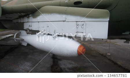 loaders position explosive ordinances, external device equipped beneath aircraft fuselage, ordnance specialists systematically stage explosive devices under aircraft fuselage for deployment loaders position explosive ordinances, external device equipped beneath aircraft fuselage, ordnance specialists systematically stage explosive devices under aircraft fuselage for deployment 134657781