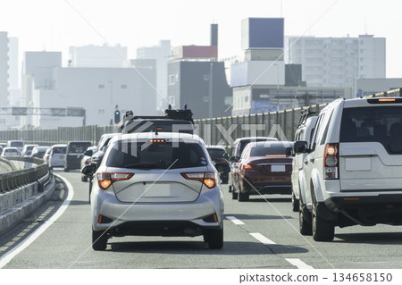 Private cars driving during rush hour on main roads 134658150