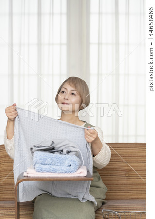 Senior woman doing housework laundry Senior woman doing housework laundry 134658466
