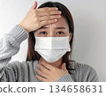 Woman with a cold, fever and sore throat 134658631