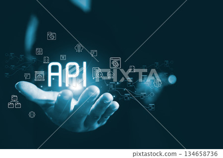 Glowing API concept floating above human hand connected digital icon representing application programming interface system integration data exchange cloud services modern scalable technology solutions Glowing API concept floating above human hand connected digital icon representing application programming interface system integration data exchange cloud services modern scalable technology solutions 134658736