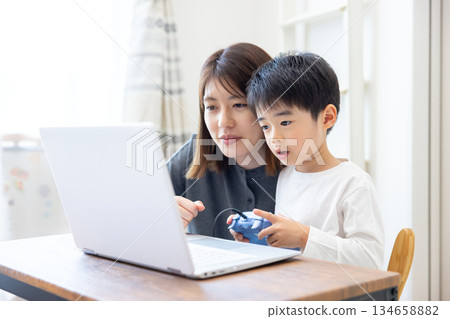 家庭：男孩和媽媽一起玩電腦遊戲 134658882