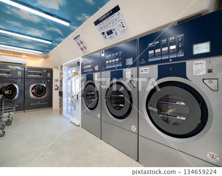 A laundromat with rows of washing machines A laundromat with rows of washing machines 134659224