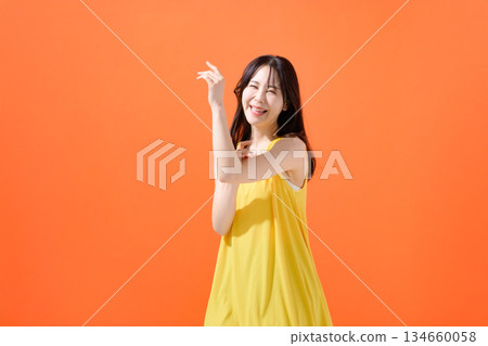Orange background female portrait Orange background female portrait 134660058
