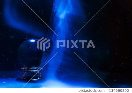 Crystal magical glass ball, mystical smoke and abstract light painting on dark background. Forecasting AI intuition, data flow, future technology. 134660200