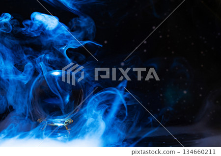 Crystal magical glass ball, mystical smoke and abstract light painting on dark background. Forecasting AI intuition, data flow, future technology. 134660211
