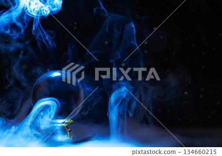 Crystal magical glass ball, mystical smoke and abstract light painting on dark background. Forecasting AI intuition, data flow, future technology. 134660215