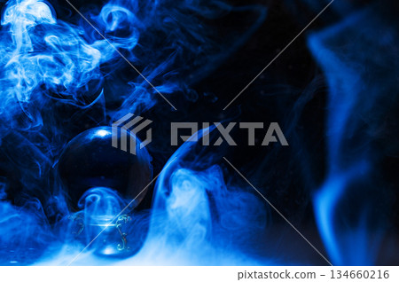 Crystal magical glass ball, mystical smoke and abstract light painting on dark background. Forecasting AI intuition, data flow, future technology. 134660216