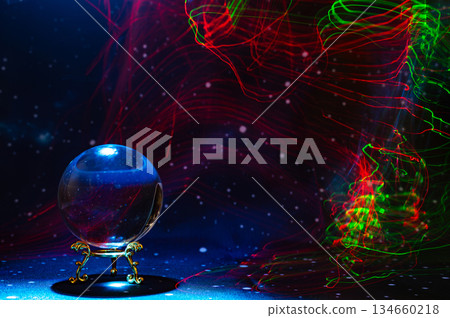 Crystal magical glass ball, mystical smoke and abstract light painting on dark background. Forecasting AI intuition, data flow, future technology. 134660218
