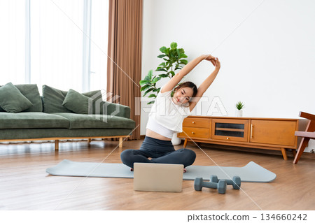 Young Asian woman stretching yoga workout on exercise mat Young Asian woman stretching yoga workout on exercise mat 134660242