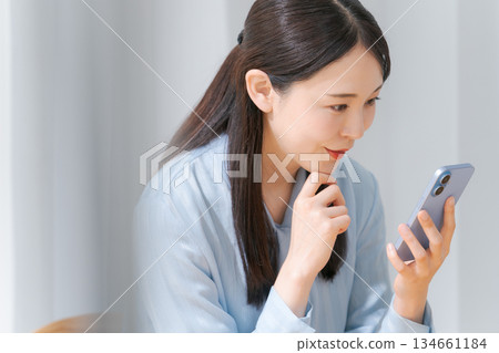 Young woman looking at a smartphone 134661184