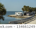 Travelling by motor home during road trip in USA. Camper vehicle on ocean shore in Florida. 134661249