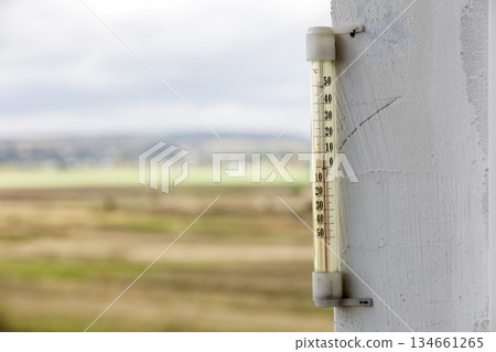 Alcohol glass thermometer Celsius outside on bright blurred light outdoors copy space background. 134661265