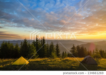 Tourist camping tent on mountain campsite at bright sunny evening. Active tourism and hiking concept 134661269