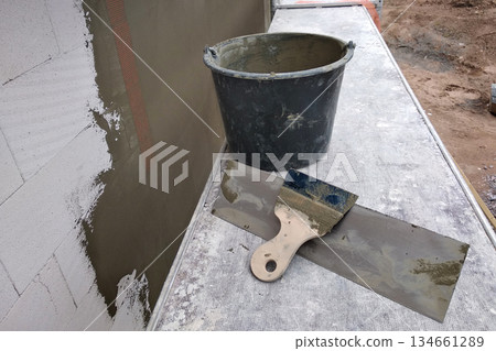 Tools and material foe covering walls with protective adhesive before finish paint. Tools and material foe covering walls with protective adhesive before finish paint. 134661289