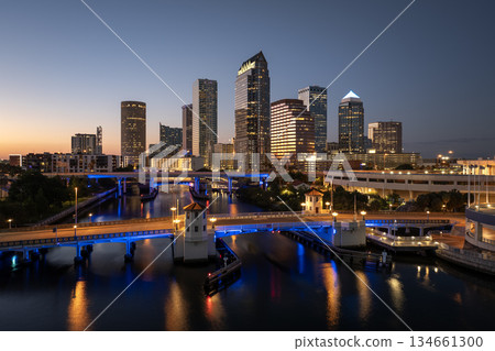 Tampa, Florida. Cars traffic driving on highway bridge and high skyscraper buildings in downtown district. American city with business financial district at nightfall Tampa, Florida. Cars traffic driving on highway bridge and high skyscraper buildings in downtown district. American city with business financial district at nightfall 134661300