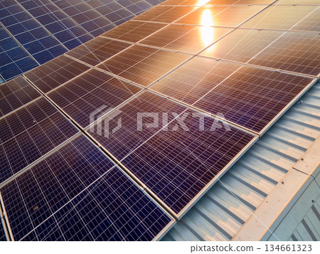 Solar photovoltaic panels installed on building roof for producing clean ecological electric energy. Renewable electricity with zero emission concept. 134661323