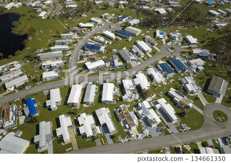 Severely damaged houses after hurricane Ian in Florida mobile home residential area. Consequences of natural disaster 134661350