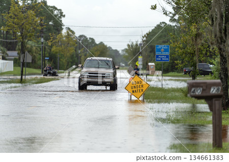 Road under water warning sign. City street closed because of flooding danger blocking driving of cars Road under water warning sign. City street closed because of flooding danger blocking driving of cars 134661383