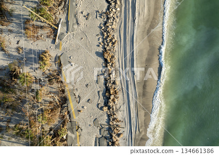 Road erosion after hurricane in Florida. Storm surge washed away asphalt on Manasota Key road at Blind Pass Beach. Severe damage to waterfront infrastructure 134661386
