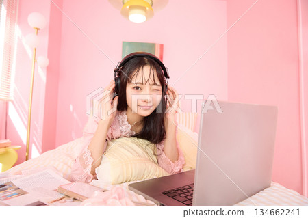 一位年輕的亞洲女性身穿睡衣，在溫馨的房間裡放鬆休息的肖像 134662241