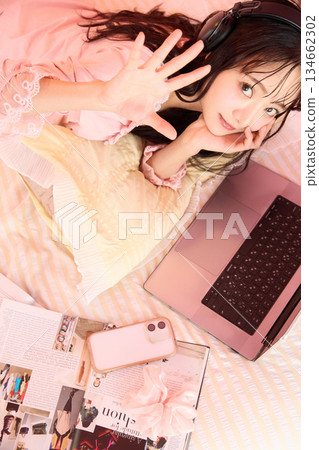 Portrait of a young Asian woman relaxing in pajamas in a cute room 134662302