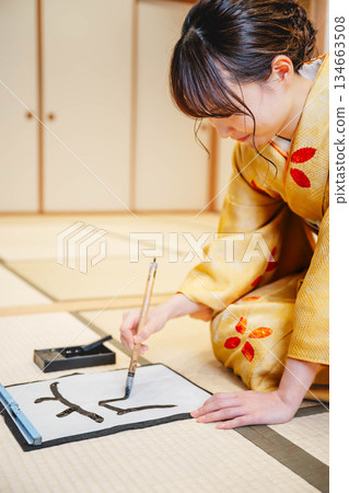 Kimono woman doing calligraphy Kimono woman doing calligraphy 134663508