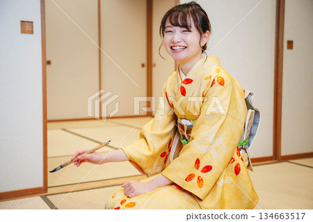 Kimono woman doing calligraphy Kimono woman doing calligraphy 134663517
