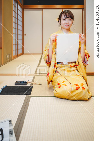Kimono woman doing calligraphy Kimono woman doing calligraphy 134663526