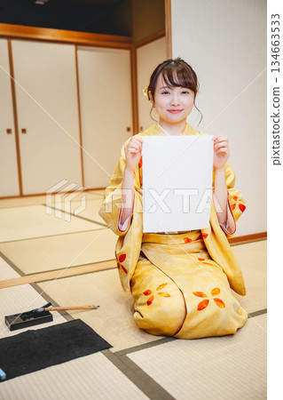 Kimono woman doing calligraphy Kimono woman doing calligraphy 134663533