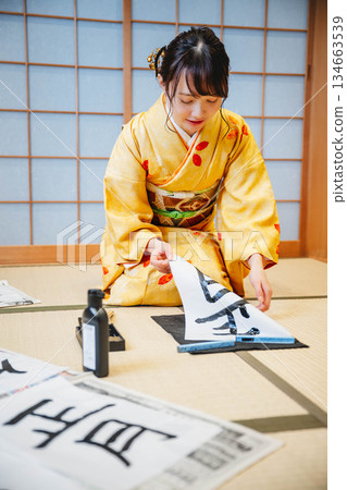 Kimono woman doing calligraphy Kimono woman doing calligraphy 134663539