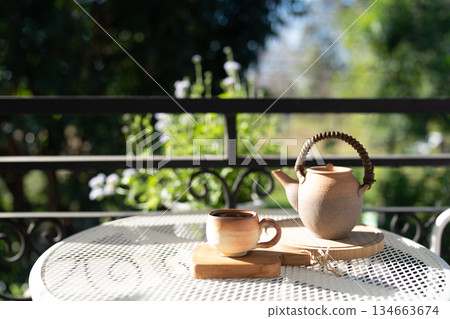 earthenware Tea set on balcony outdoor in winter under strong sunlight 134663674