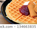 Delicious thin Nordic waffles served with strawberry jam, cream and brown cheese 134663835