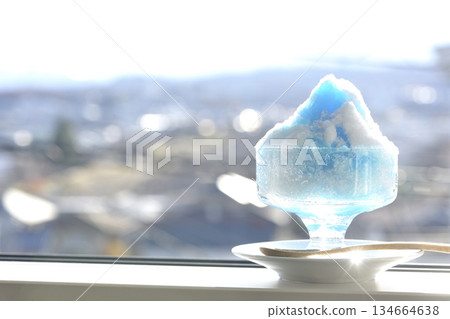 Blue Hawaii shaved ice on a windowsill Blue Hawaii shaved ice on a windowsill 134664638
