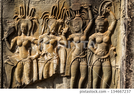 Beautiful bas-relief carving of celestial Apsara dancers with intricate details on stone wall of Khmer temple in Siem Reap Cambodia 134667237
